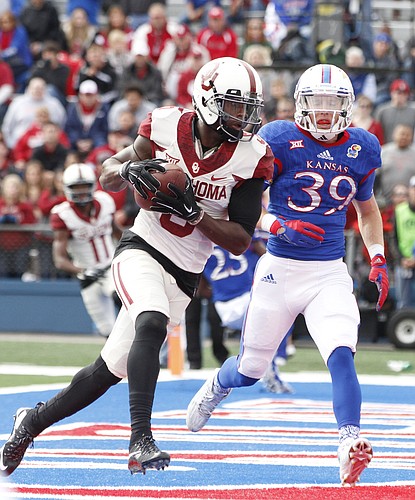 Oklahoma wide receiver Durron Neal (5) pulls in a touchdown catch before Kansas safety Michael Glatczak (39) during the first quarter Saturday, Oct. 31, 2015 at Memorial Stadium.