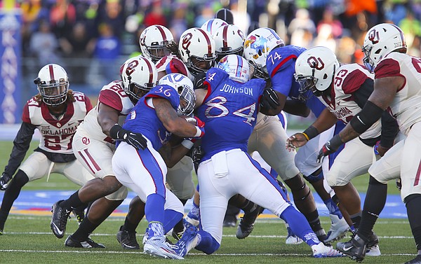 Kansas running back Taylor Cox (36) and his blocker tight end Ben Johnson (84) are stopped by a wall of Oklahoma defenders on a run during the third quarter, Saturday, Oct. 31, 2015 at Memorial Stadium.