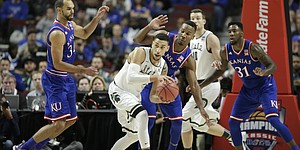 Kansas players Perry Ellis, left, and Wayne Selden hound Michigan State guard Denzel Valentine during the first half, Tuesday, Nov. 17, 2015 at United Center in Chicago.