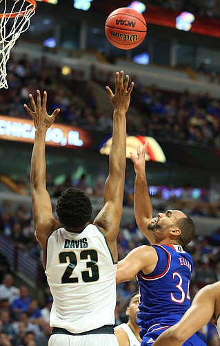 Kansas forward Perry Ellis (34) turns for a shot over Michigan State forward Deyonta Davis (23) during the first half, Tuesday, Nov. 17, 2015 at United Center in Chicago.