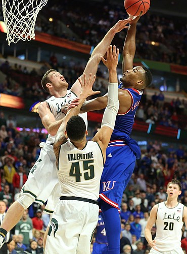 Kansas guard Wayne Selden Jr. (1) tries to put up a shot with seconds remaining over Michigan State forward Matt Costello  and guard Denzel Valentine (45) during the second half, Tuesday, Nov. 17, 2015 at United Center in Chicago.
