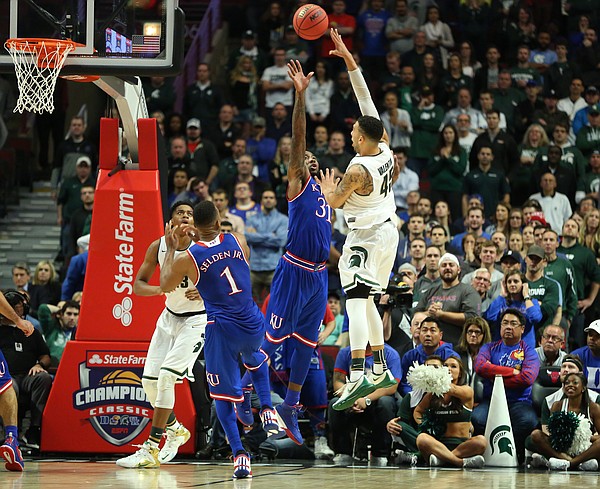 Michigan State guard Denzel Valentine (45) puts a shot up over Kansas forward Jamari Traylor (31) late in the second half, Tuesday, Nov. 17, 2015 at United Center in Chicago.