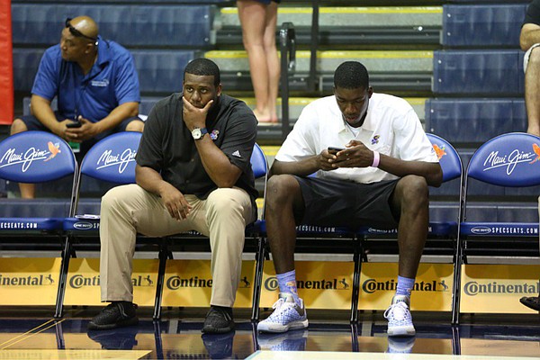 Kansas University freshman Cheick Diallo sits on the bench with assistant coach Jerrance Howard before the start of the Jayhawks' opening-round game at the Maui Invitational, against Chaminade, on Nov. 23, 2015.