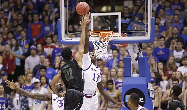 Kansas forward Cheick Diallo (13) gets a hand up in front of a shot by Loyola forward Jarred Jones (21) during the first half, Tuesday, Dec. 1, 2015 at Allen Fieldhouse.