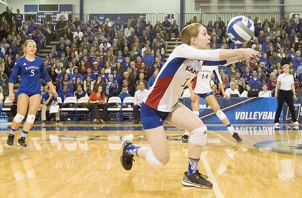 Kansas senior Anna Church (1) keeps the ball in play off a block during Kansas' second round NCAA volleyball tournament match against Missouri on Friday night at the Horejsi Center. The Jayhawks sent the Tigers packing with a three set sweep. 