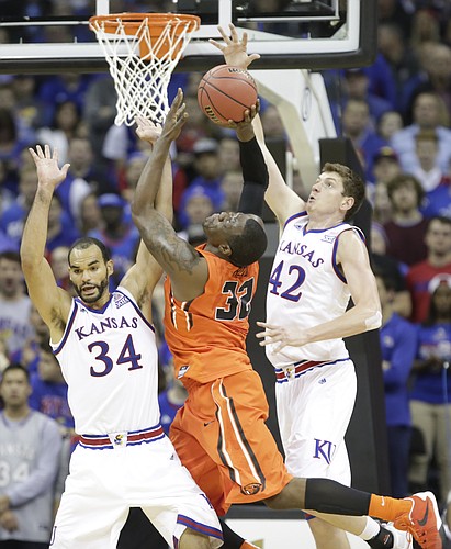 Kansas forward Hunter Mickelson (42) elevates to stuff  a shot by Oregon State forward Jarmal Reid (32) during the second half, Saturday, Dec. 12, 2015 at Sprint Center. At left is Kansas forward Perry Ellis (34). Mickelson was called for a foul on the play.