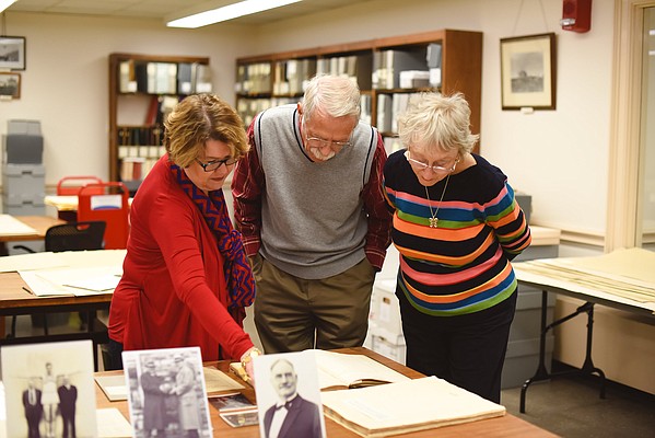 Kansas University Archivist Rebecca Schulte (left), Jim Naismith and his wife, Beverly Naismith, look over James Naismith items at KU's Spencer Research Library during a visit by the Naismith's to Lawrence. Jim Naismith of Portland, Texas, is the grandson of James Naismith, inventor of basketball and a former KU basketball coach and athletics director. 