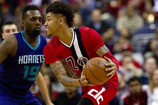 Washington Wizards forward Kelly Oubre Jr. (12), handles the ball against Charlotte Hornets forward P.J. Hairston (19), in the first half of an NBA basketball game at the Verizon Center in Washington on Saturday, Dec. 19, 2015. This was Oubre's first game as a starter. The Wizards won 109-101. (AP Photo/Jacquelyn Martin)
