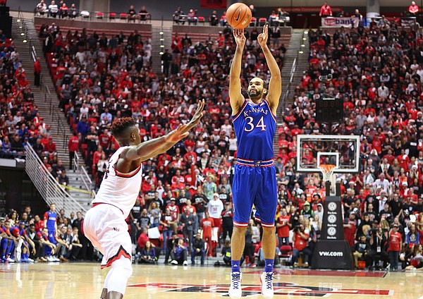 Kansas forward Perry Ellis (34) puts up a three against San Diego State forward Zylan Cheatham (14) during the first half, Tuesday, Dec. 22, 2015 at Viejas Arena in San Diego.