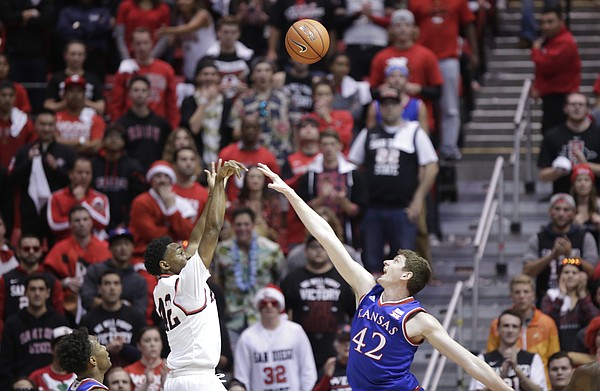 San Diego State guard Jeremy Hemsley (42) puts a shot over Kansas forward Hunter Mickelson (42) during the first half, Tuesday, Dec. 22, 2015 at Viejas Arena in San Diego.
