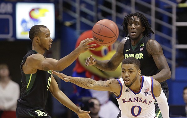 Kansas guard Frank Mason III (0) defends against a pass from Baylor guard Lester Medford (11) during the second half, Saturday, Jan. 2, 2016 at Allen Fieldhouse. In back is Baylor forward Taurean Prince (21).