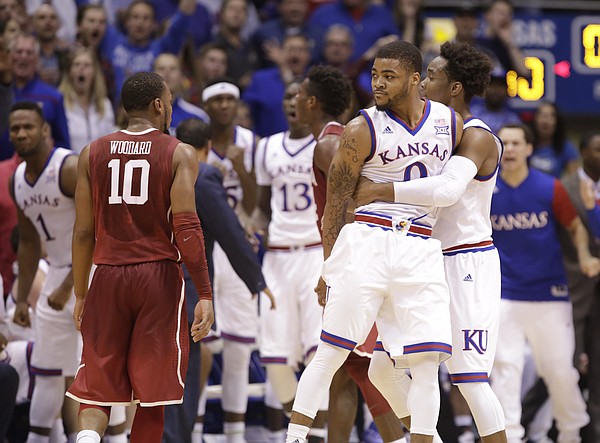 Kansas guard Frank Mason III (0) is held back by Kansas guard Devonte' Graham (4) after he was whistled for a foul on Oklahoma guard Buddy Hield (24) with seconds remain during the first half, Monday, Jan. 4, 2016 at Allen Fieldhouse.