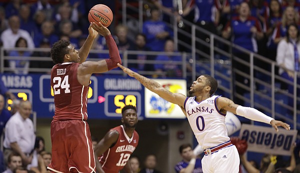 Kansas guard Frank Mason III (0) defends against a three from Oklahoma guard Buddy Hield (24) during the second half, Monday, Jan. 4, 2016 at Allen Fieldhouse.