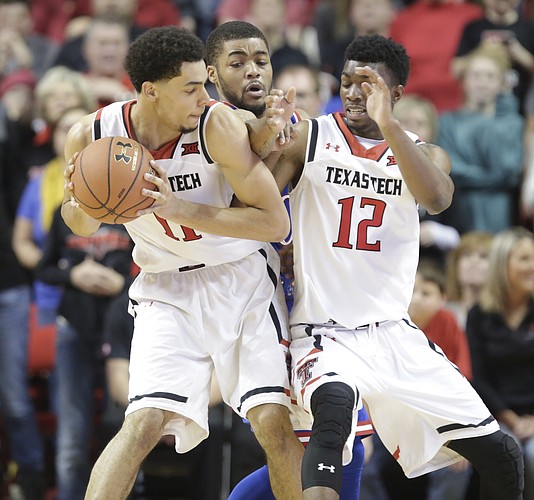 Kansas guard Frank Mason III tries to cut between Texas Tech forward Zach Smith (11) and guard Keenan Evans (12) for an attempted steal during the second half, Saturday, Jan. 9, 2016 at United Spirit Arena in Lubbock, Texas.