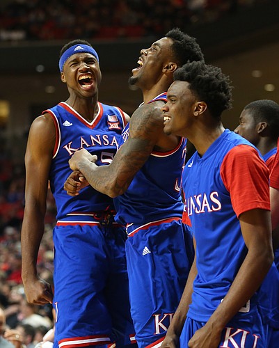 Kansas forward Carlton Bragg Jr. left, forward Jamari Traylor and guard Lagerald Vick celebrate a lob dunk to forward Perry Ellis to widen the Jayhawk's lead late in the second half, Saturday, Jan. 9, 2016 at United Spirit Arena in Lubbock, Texas.
