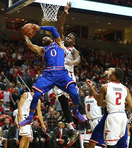 Kansas guard Frank Mason III (0) is fouled on his way up to the bucket by Texas Tech center Norense Odiase (32) during the first half, Saturday, Jan. 9, 2016 at United Spirit Arena in Lubbock, Texas.