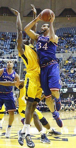 Kansas forward Perry Ellis drives to the basket for two points in a game between the Jayhawks and the Mountaineers at the WVU Colliseum in Morgantown, W.V. Tuesday.