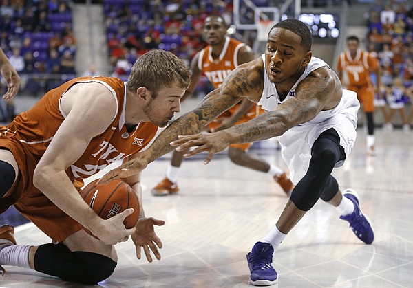 Texas forward Connor Lammert, left, grabs a loose ball next to TCU guard Malique Trent during the first half of an NCAA college basketball game Saturday, Jan. 9, 2016, in Fort Worth, Texas. (AP Photo/Ron Jenkins)