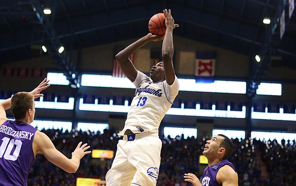 Kansas forward Cheick Diallo (13) pulls up for a jumper over TCU forward Vladimir Brodziansky (10) and guard Michael Williams (2) during the second half, Saturday, Jan. 16, 2016 at Allen Fieldhouse.