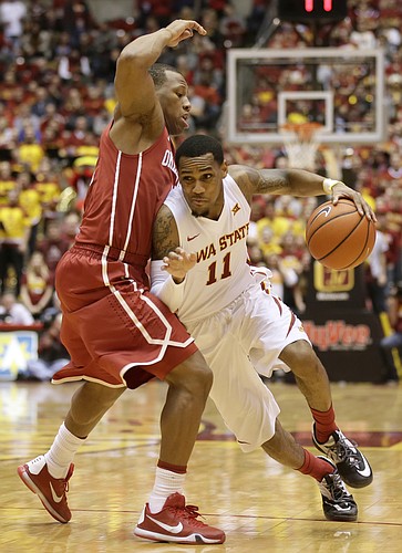 Iowa State guard Monte Morris drives around Oklahoma guard Dinjiyl Walker, left, during the second half of an NCAA college basketball game, Monday, Jan. 18, 2016, in Ames, Iowa. Iowa State won 82-77. (AP Photo/Charlie Neibergall)