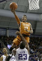 Texas guard Kerwin Roach Jr. (12) drives inside and shoots over TCU forward Devonta Abron (23) during the first half of an NCAA college basketball game, Saturday, Jan. 9, 2016, in Fort Worth, Texas. (AP Photo/Ron Jenkins)