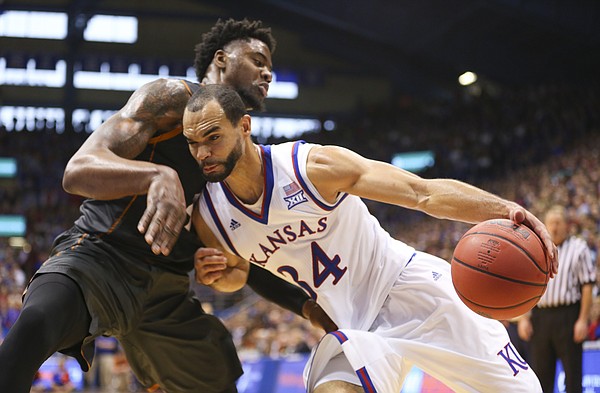 Kansas forward Perry Ellis (34) bangs into Texas center Prince Ibeh as he heads to the bucket during the second half, Saturday, Jan. 23, 2016 at Allen Fieldhouse.