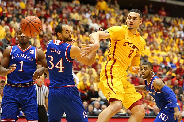 Iowa State forward Abdel Nader (2) throws a backdoor pass around Kansas forward Perry Ellis (34) and guard Wayne Selden Jr. (1) during the first half, Monday, Jan. 25, 2016 at Hilton Coliseum in Ames, Iowa. Also pictured is Kansas guard Frank Mason III (0).