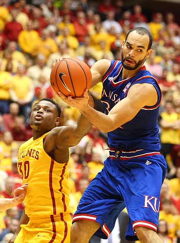 Kansas forward Perry Ellis (34) catches a pass inside before Iowa State guard Deonte Burton (30) during the second half, Monday, Jan. 25, 2016 at Hilton Coliseum in Ames, Iowa.