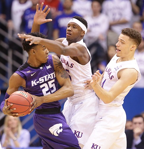 Kansas forward Carlton Bragg Jr. and Kansas guard Brannen Greene, right, try to smother a pass from Kansas State forward Wesley Iwundu (25) during the first half on Wednesday, Feb. 3, 2016 at Allen Fieldhouse.