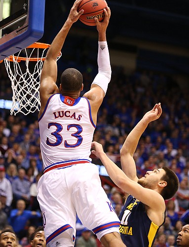 Kansas forward Landen Lucas (33) gets up for a lob dunk over West Virginia forward Nathan Adrian (11) during the first half, Tuesday, Jan. 9, 2016 at Allen Fieldhouse.