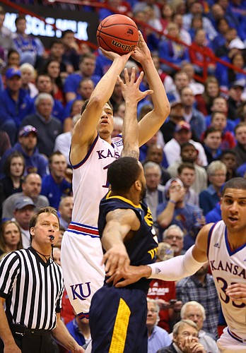 Kansas guard Brannen Greene (14) puts a three over West Virginia guard Jaysean Paige (5) from the wing during the second half, Tuesday, Jan. 9, 2016 at Allen Fieldhouse.
