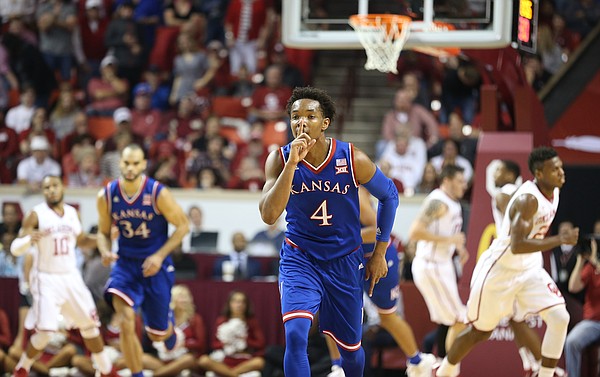 Kansas guard Devonte' Graham (4) shushes the crowd after hitting a three during the first half, Saturday, Feb. 13, 2016 at Lloyd Noble Center in Norman, Okla.