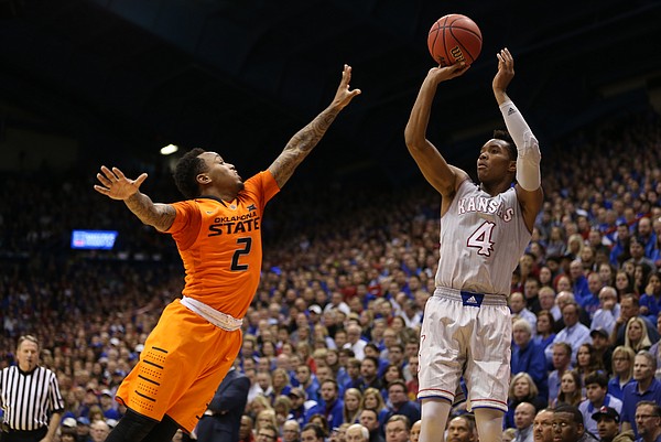 Kansas guard Devonte' Graham (4) pulls up for a three against Oklahoma State guard Tyree Griffin (2) during the second half, Monday, Feb. 15, 2016 at Allen Fieldhouse.