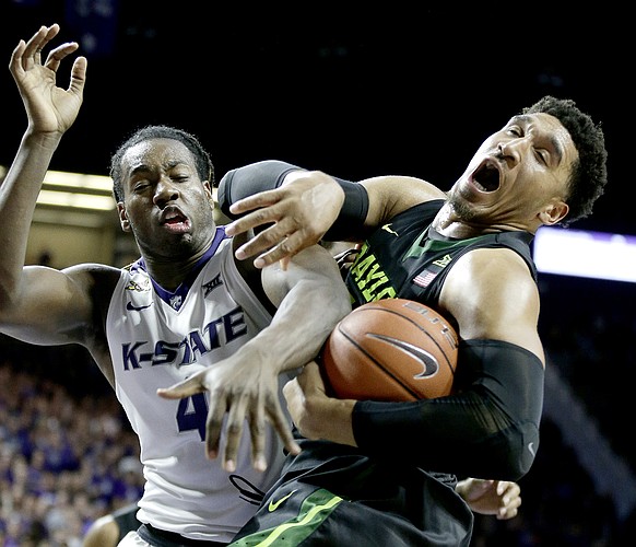 Kansas State's D.J. Johnson (4) and Baylor's Ishmail Wainright battle for a rebound during the second half of an NCAA college basketball game Wednesday, Feb. 10, 2016, in Manhattan, Kan. Baylor won 82-72. (AP Photo/Charlie Riedel)