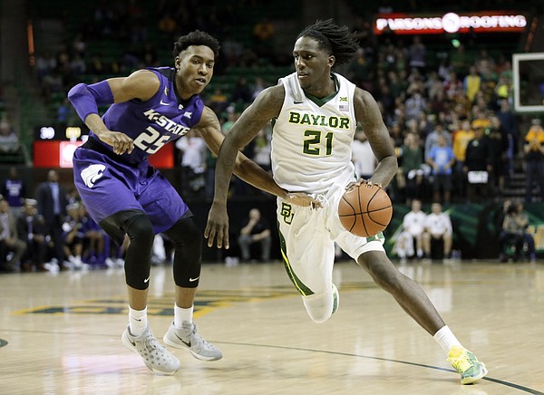 Kansas State's Wesley Iwundu (25) defends as Baylor's Taurean Prince (21) drives to the basket in the second half of an NCAA college basketball game, Wednesday, Jan. 20, 2016, in Waco, Texas. Baylor won in double overtime, 79-72. (AP Photo/Tony Gutierrez)
