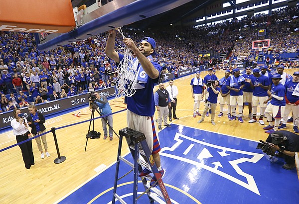 Kansas forward Perry Ellis finishes off the net as his teammates and the fieldhouse stand to watch as the Jayhawks celebrate locking up a share of their twelfth-straight Big 12 title following their 67-58 win over the Red Raiders, Saturday, Feb. 27, 2016 at Allen Fieldhouse.