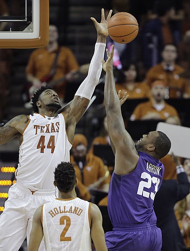 TCU forward Devonta Abron (23) is blocked by Texas center Prince Ibeh (44) as he drives to the basket during the second half of an NCAA college basketball game, Tuesday, Jan. 26, 2016, in Austin, Texas. Texas won 71-54. (AP Photo/Eric Gay)