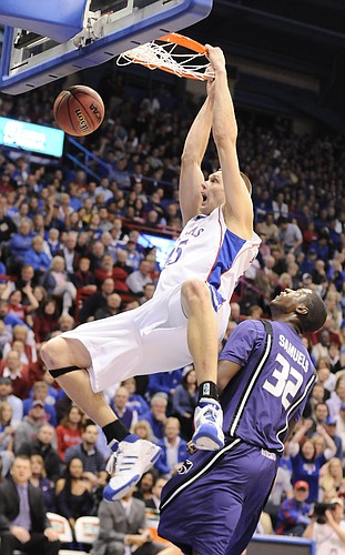 (FILE) Kansas center Cole Aldrich delivers a thunderous dunk over Kansas State forward Jamar Samuels during the first half Tuesday, Jan. 13, 2009 at Allen Fieldhouse.
