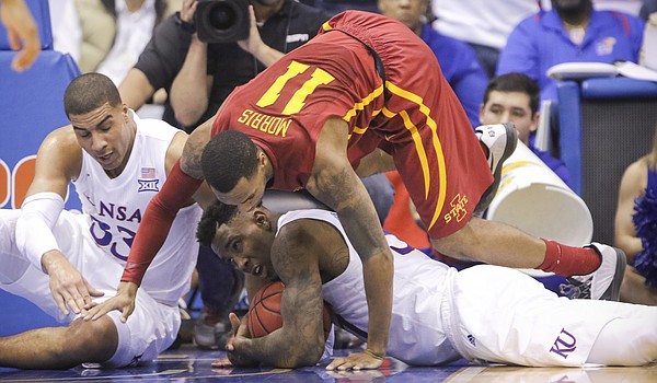Iowa State guard Monte Morris (11) falls on top of Kansas forward Jamari Traylor (31) as Traylor slides to secure a loose ball during the second half, Saturday, March 5, 2016 at Allen Fieldhouse. At left is Kansas forward Landen Lucas (33).