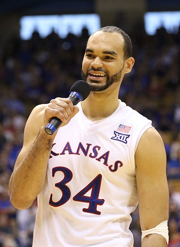 Kansas forward Perry Ellis (34) jokes with the coaching staff during the Senior Day speeches following the JayhawksÕ 85-78 win over the Cyclones