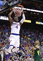 Kansas guard Devonte' Graham (4) delivers on a lob jam before Baylor guard Al Freeman (25) during the first half, Friday, March 11, 2016 at Sprint Center in Kansas City, Mo.