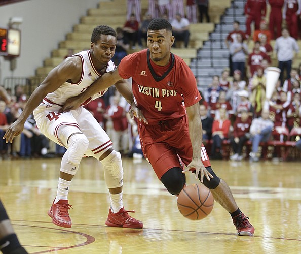 Austin Peay's Josh Robinson (4) is defended by Indiana's Yogi Ferrell (11) during the first half of an NCAA college basketball game Monday, Nov. 16, 2015, in Bloomington, Ind. (AP Photo/Darron Cummings)