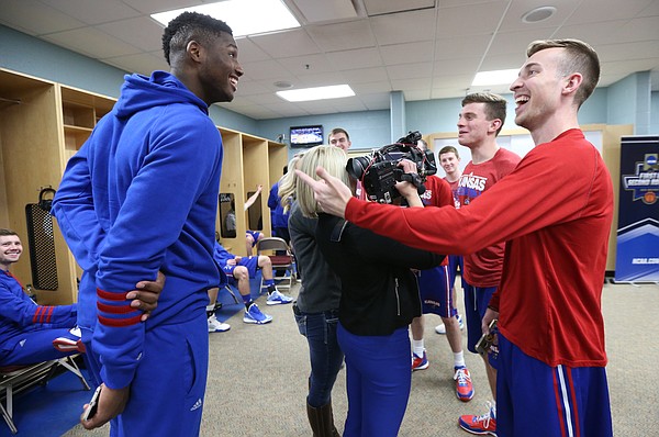 Kansas forward Carlton Bragg Jr. (15) jokes with student manager Chip Kueffer as Kueffer and other student managers are interviewed by media members, Friday, March 18, 2016 at Wells Fargo Arena in Des Moines.