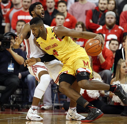 Maryland's Robert Carter, right, drives against Ohio State's JaQuan Lyle during an NCAA college basketball game in Columbus, Ohio, Sunday, Jan. 31, 2016. Maryland won 66-61. (AP Photo/Paul Vernon)