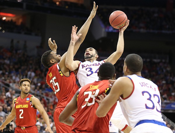 Kansas Jayhawks forward Perry Ellis (34) gets to the bucket against Maryland forward Damonte Dodd (35) during the first half, Thursday, March 24, 2016 at KFC Yum! Center in Louisville, Kentucky.