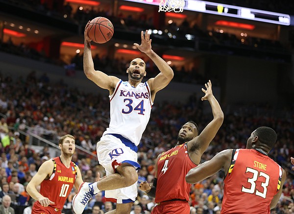 Kansas Jayhawks forward Perry Ellis (34) gets to the bucket past Maryland forward Robert Carter (4) during the first half, Thursday, March 24, 2016 at KFC Yum! Center in Louisville, Kentucky.