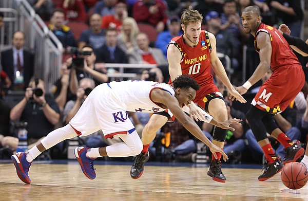 Kansas guard Devonte' Graham (4) lays out for a loose ball with Maryland forward Jake Layman (10) and guard Rasheed Sulaimon (0) during the second half, Thursday, March 24, 2016 at KFC Yum! Center in Louisville, Kentucky.
