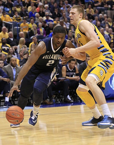 Villanova forward Kris Jenkins, left, drives to the basket against Marquette forward Henry Ellenson, right, during the second half of an NCAA college basketball game Saturday, Feb. 27, 2016, in Milwaukee. Villanova defeated Marquette 89-79. (AP Photo/Darren Hauck)