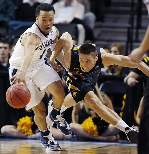 Villanova guard Jalen Brunson (1) holds back Iowa forward Jarrod Uthoff (20) during the second half of a second-round NCAA men's college basketball tournament game, Sunday, March 20, 2016, in New York. (AP Photo/Kathy Willens)
