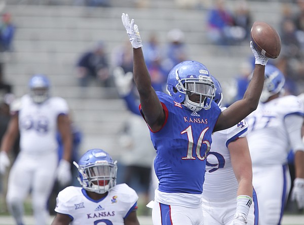 Kansas wide receiver Steven Sims Jr. (16) throws up his arms after falling into the end zone for a touchdown during the Spring Game on Saturday, April 9, 2016 at Memorial Stadium.